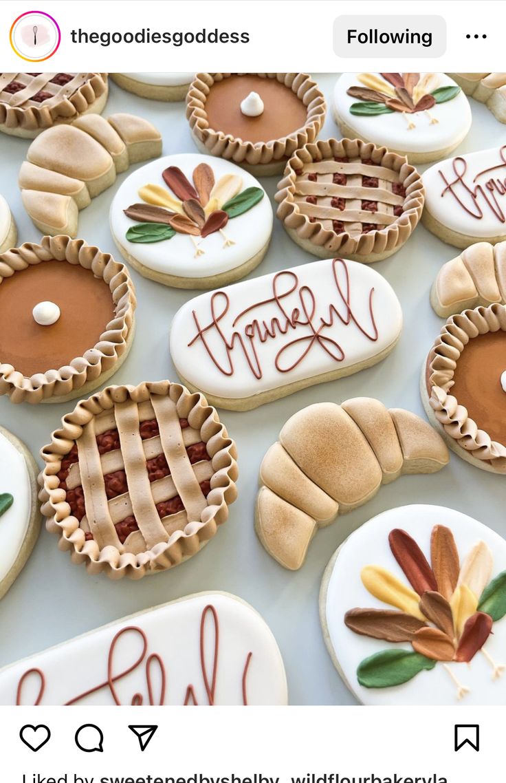 some cookies that are on top of a white table and one is decorated with thanksgiving decorations