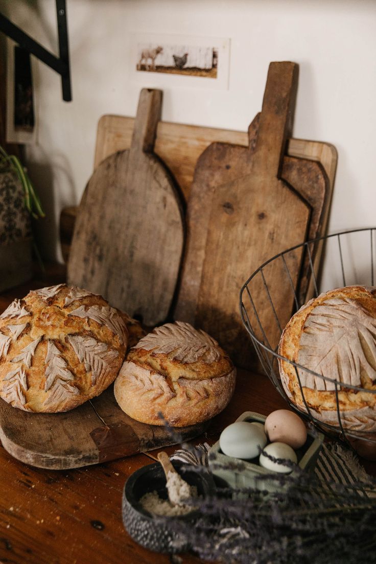 two loaves of bread sitting on top of a wooden table