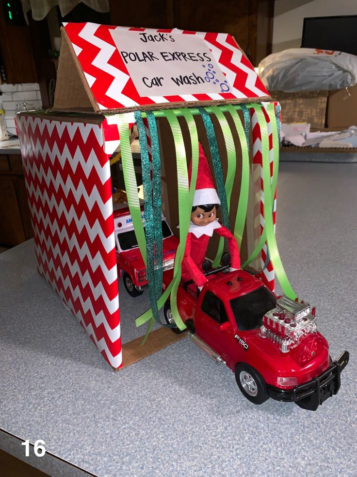 an elf is driving a red car under a tent