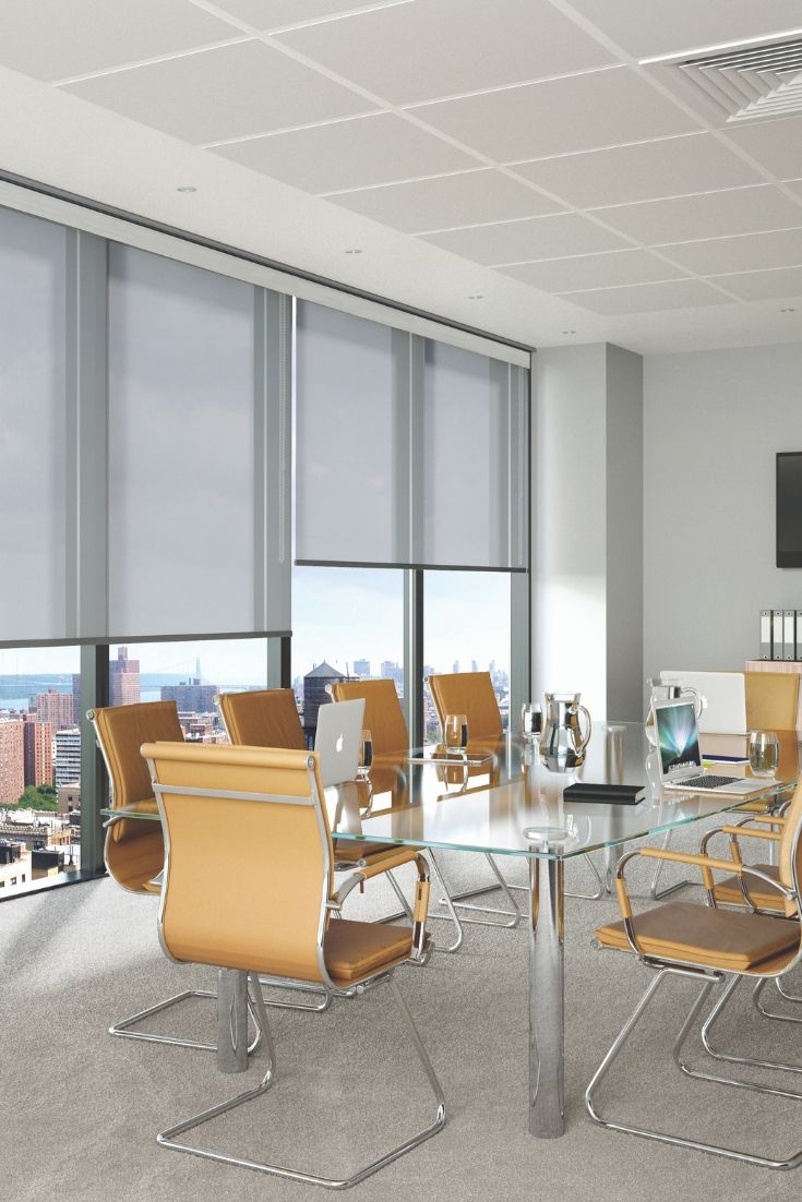 an empty conference room with chairs and a table in front of large windows overlooking the city