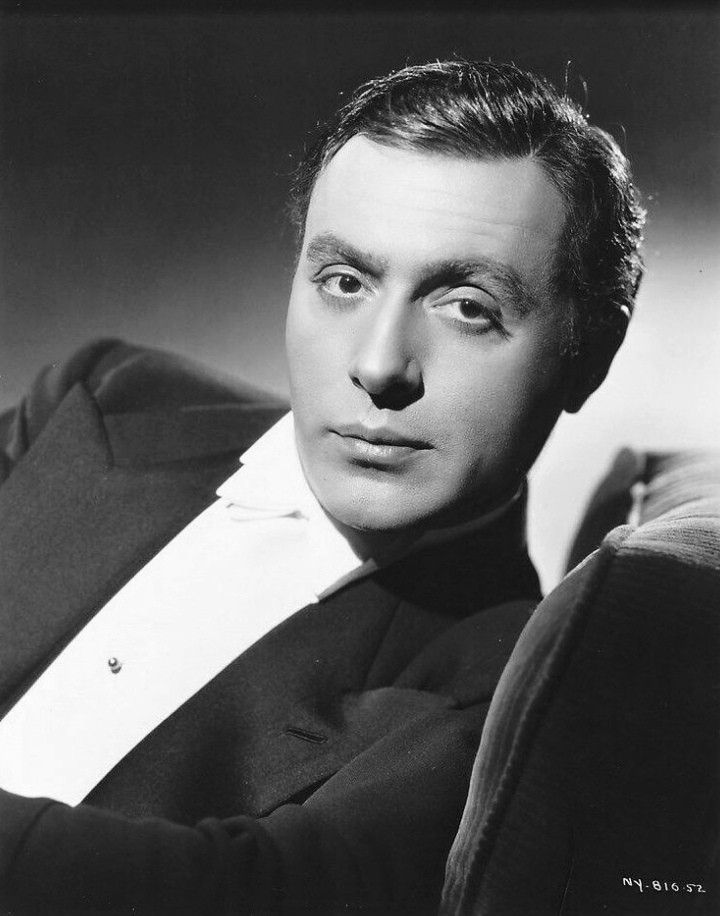 black and white photograph of a man in a tuxedo looking at the camera