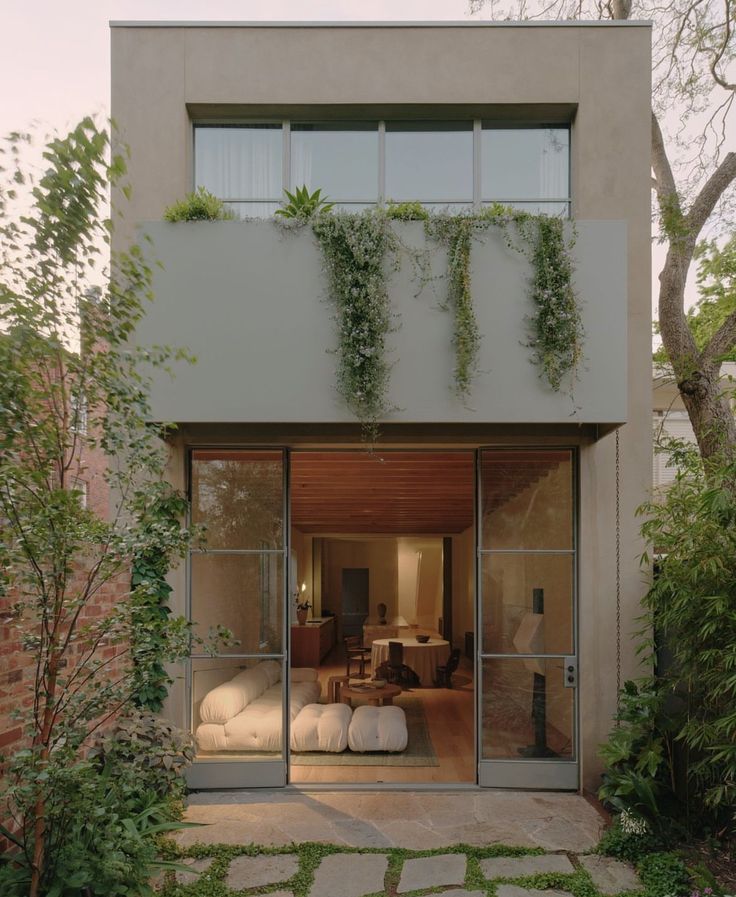 an outside view of a house with plants growing on the wall