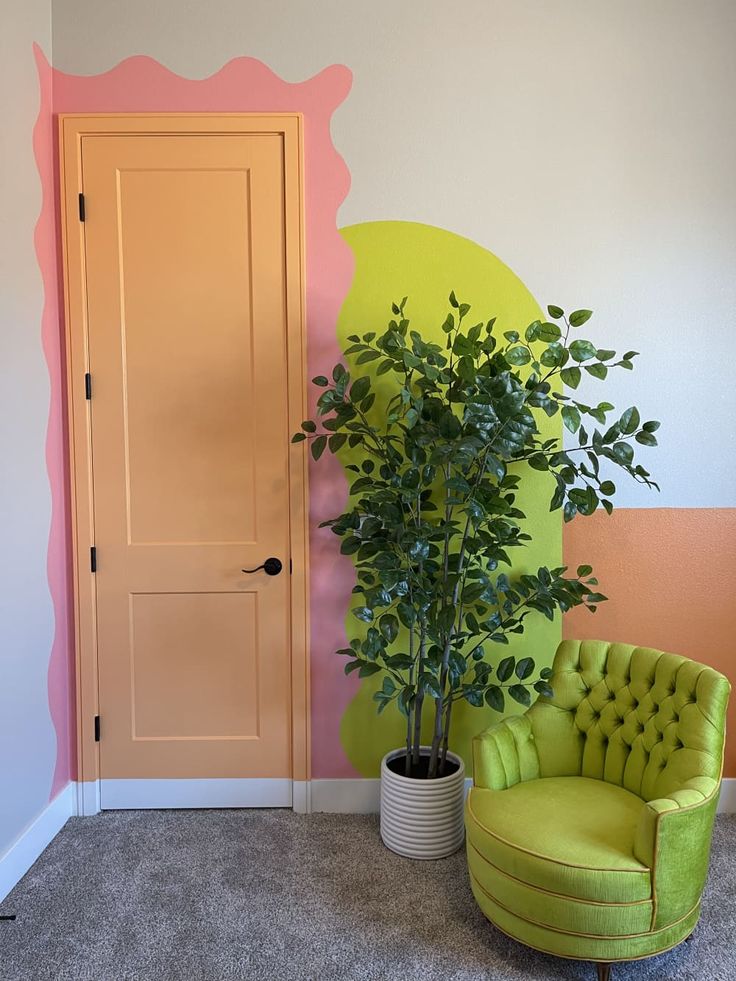 a green chair sitting in front of a door next to a potted plant on top of a table