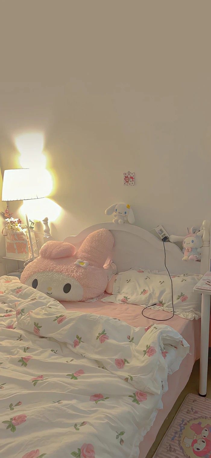 a bedroom with a hello kitty bed and pink comforter on the bedspread