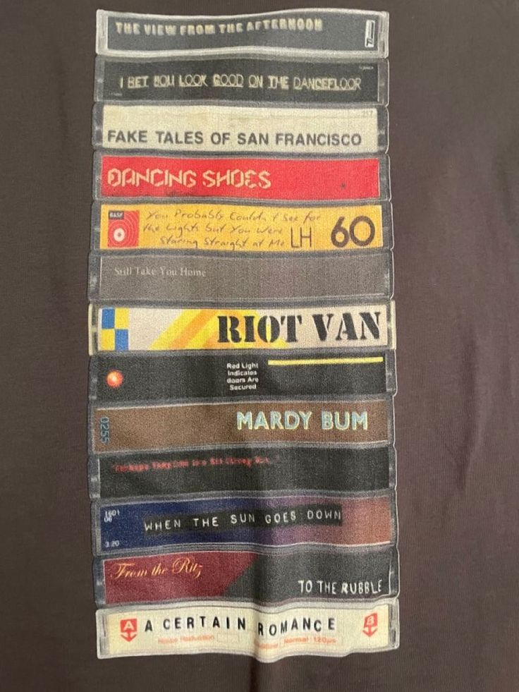 a stack of books sitting on top of a brown tablecloth covered in different types of bookmarks