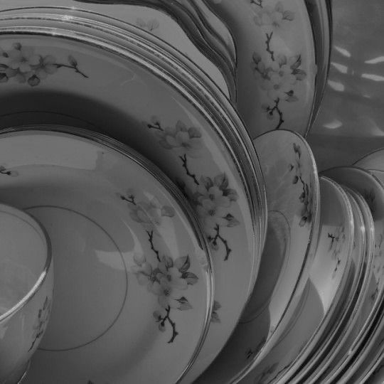 a stack of plates with flowers painted on them