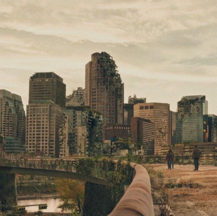 a person taking a photo with their cell phone in front of a cityscape