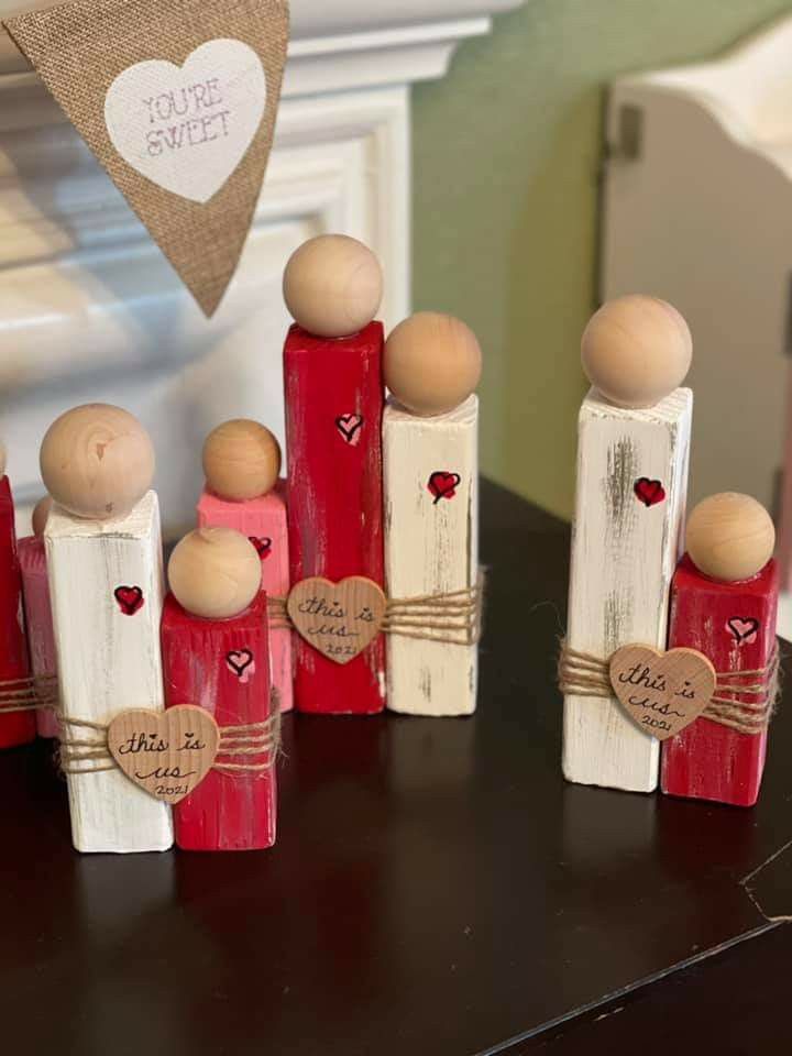 small red and white wooden pegs with hearts on them are sitting on a table