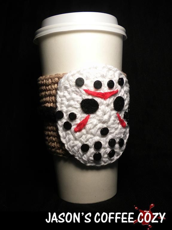 a white coffee cup with a crocheted snowman face on the front and bottom