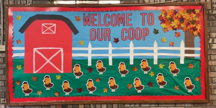 a welcome to our coop sign hanging on the side of a brick building in front of a fence