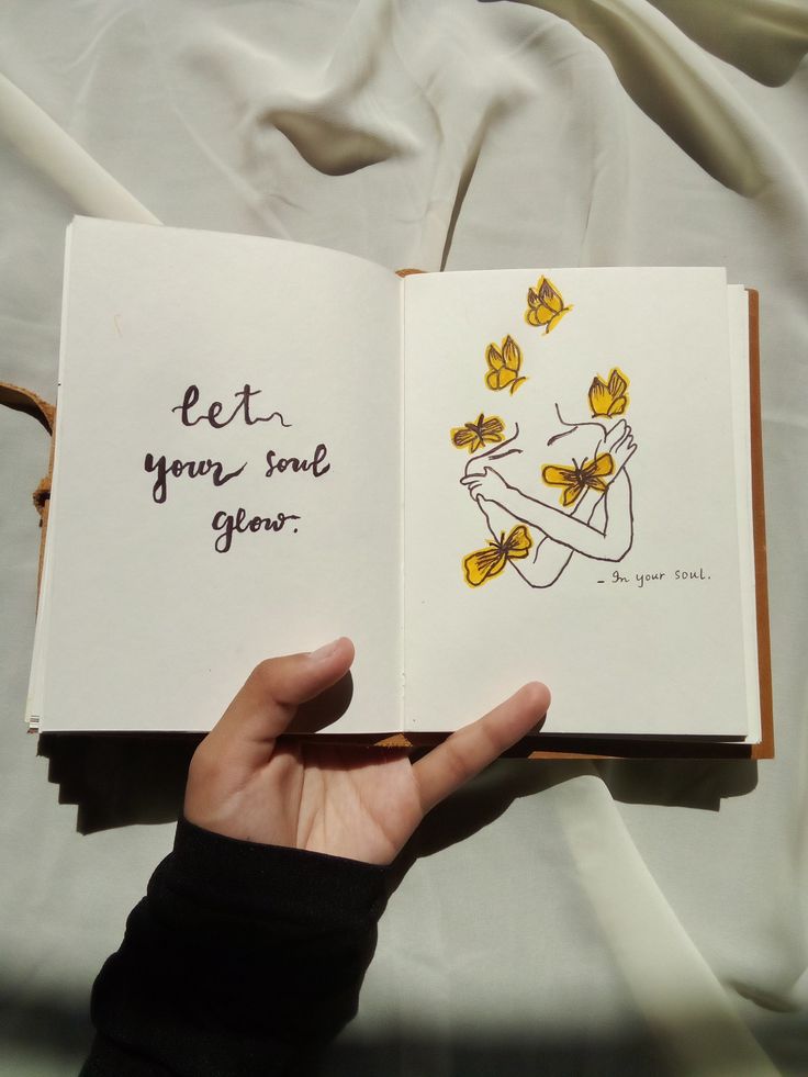 a person is holding an open book with drawings on it and the words let your love grow