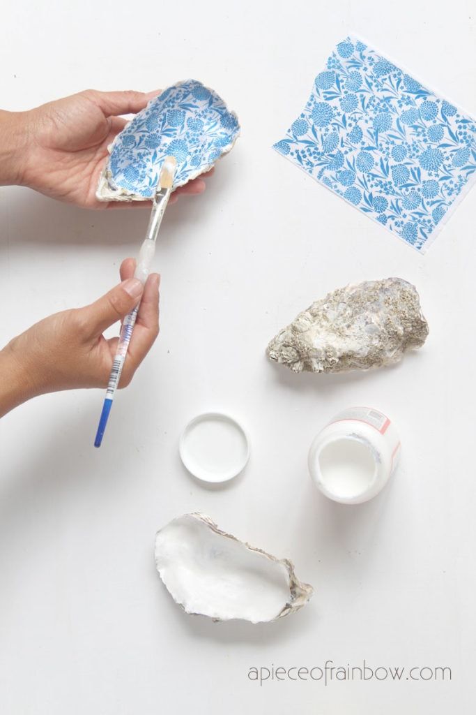 someone is painting rocks and other items on a table