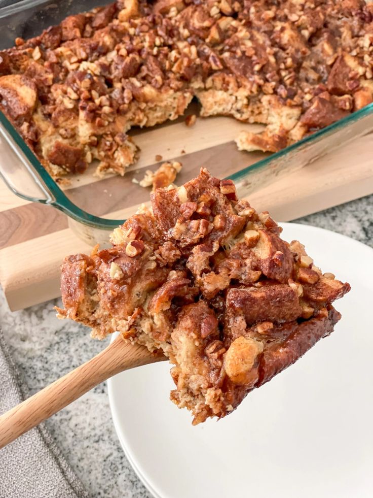 a close up of a piece of cake on a plate with a wooden spatula