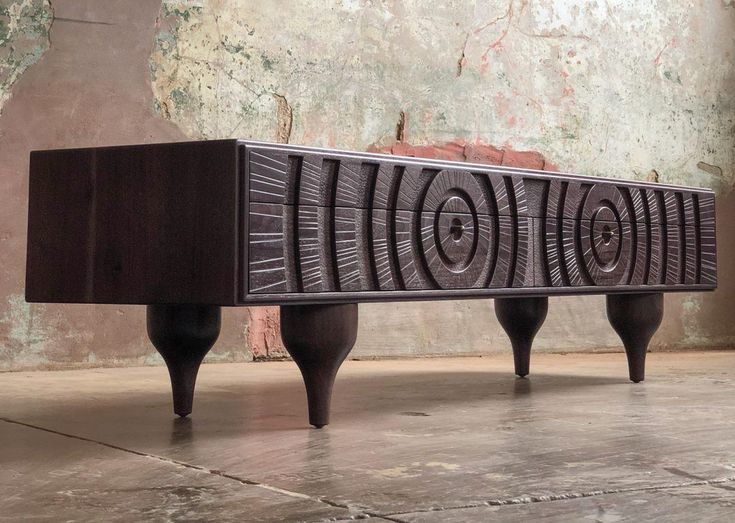 a wooden bench sitting on top of a cement floor