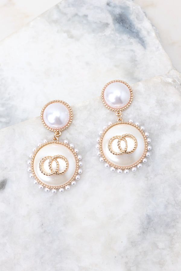 Look elegant and glamorous with these Graceful Glamour Pearl Earrings! These earrings put the “glam” in glamourous! Shine bright with these exquisite earrings and get ready to be the belle of the ball! These earrings feature pearl studs, gold detailing, small pearls circling larger pearl dangles, and a secure post backing. • Earrings measure 2" in length and 1" in width Feminine Pearl White Pearl Earrings For Party, Chic Gold Clip-on Earrings With Pearl Drop, Elegant Party Jewelry With Pearl Buttons, Trendy Gold Pearl Earrings, Glamorous Pearl Earrings For Party, Chic Pearl Drop Earrings For Party, Chic Pearl-embellished Earrings As Gift, Chic Pearl Embellished Earrings For Gift, Chic Pearl Embellished Earrings As Gift