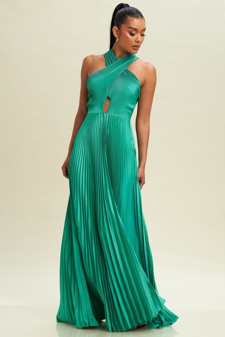 a woman in a long green dress with an asymmetrical neckline and pleated skirt