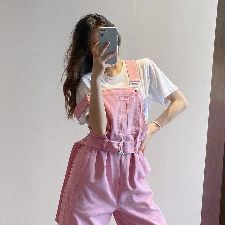 Wide Leg Belted Pink Denim Jumpsuit – Tomscloth Casual High-waisted Shortalls With Pockets, Cotton Shortalls With Suspenders For Spring, Spring Cotton Shortalls With Suspenders, Spring Cotton Jumpsuits And Rompers With Suspenders, Trendy High Waist Cotton Shortalls, Trendy High-waist Cotton Shortalls, Pink Short Overalls For Summer, Pink Shortalls With Pockets, Pink Shortalls For Summer