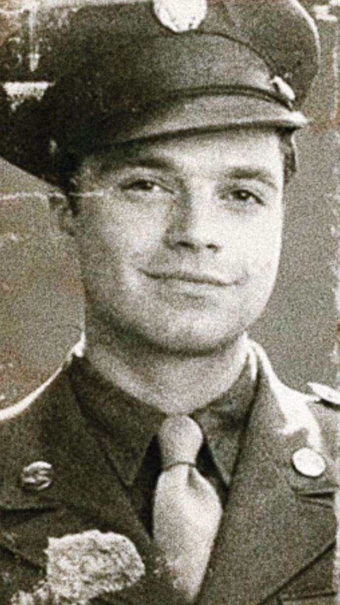 a black and white photo of a man in uniform