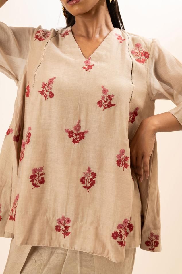 Beige tunic with scattered floral embroidery. Paired with a dhoti pant.
Components: 2
Pattern: Embroidery
Type Of Work: Floral
Neckline: V Neck
Sleeve Type: Three Quarter Sleeves
Fabric: Tunic: Chanderi, Dhoti Pant: Bamber silk, Lining: Mul cotton
Color: Beige
Other Details: 
Attached inner lining
Closure: Elastic
Occasion: Work,Resort - Aza Fashions Pant For Women, Dhoti Pants, Embroidery Floral, Pattern Embroidery, Embroidered Tunic, Floral Tunic, Three Quarter Sleeves, Quarter Sleeve, Aza Fashion