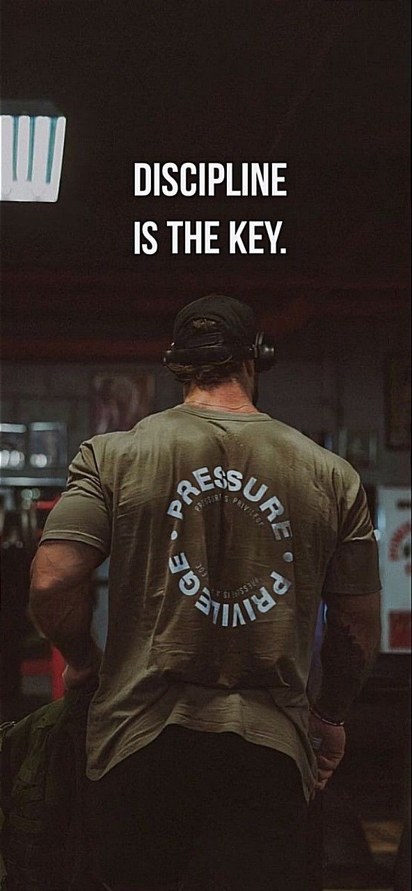 a man with a back pack walking down a street next to a sign that says, discipline is the key