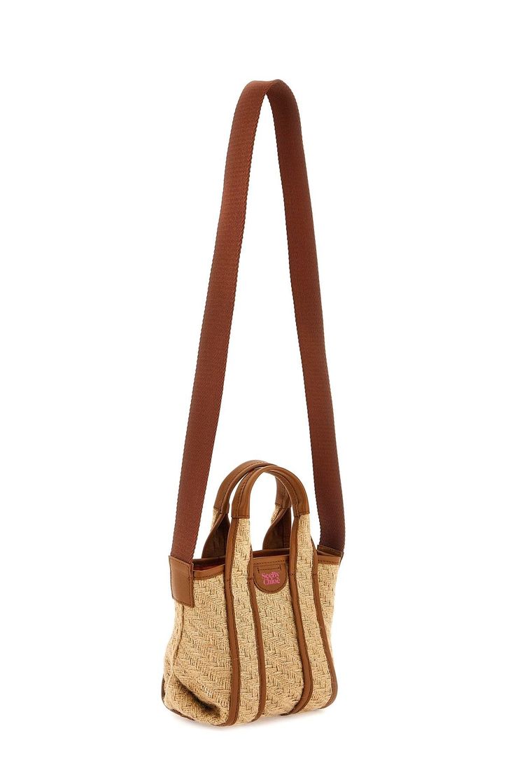 See by Chloé Leatizia tote bag made of raffia with leather details. It can be carried by hand, thanks to the double leather handle, or crossbody thanks to the fabric shoulder strap. It features contrasting logo print leather front detail, cotton canvas-lined interior with one open flat pocket. Size Info STANDARD Color Detail Mixed colours Made In India Material 100%raffia*** 100% bos taurus Season One spring Season Two summer Product bags Brand See By Chloe Size And Fit Bag Length = 21 cm, Bag H Spike Bag, Studded Bag, Small Tote Bag, Luxury Designer Handbags, Small Tote, See By Chloe, Printed Leather, Pocket Size, Nappa Leather