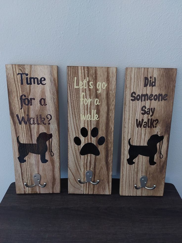 three wooden signs with dogs on them that say time for a walk, let's go do a walk and did someone say what?