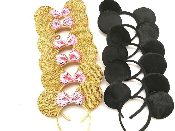 two pairs of minnie mouse ears, one with pink bows and the other with black ears