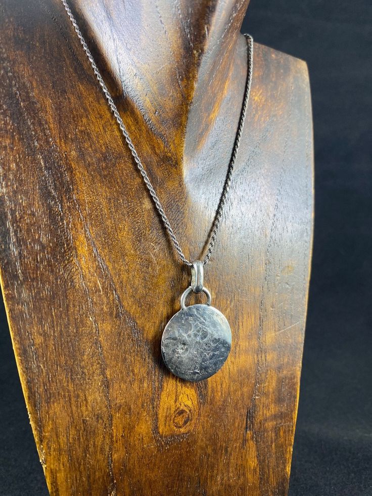 This 'Full Moon' Pendant is handmade with made of .999 Fine Silver PMC (formed from an antique button on reverse side) and added fine detail to the 'front' side which ended up turning into the moon. Oxidized to show contrast in all its moon glory, this pendant hangs from a 18" oxidized Sterling Silver diamond cut rope chain.  MADE IN MAINE. MADE WITH LOVE. ♥ Handmade Sterling Silver Coin Pendant Necklace, Handmade Sterling Silver Pendant Coin Necklace, Sterling Silver Coin Necklace With Oxidized Finish, Hand Forged Amulet Necklace With Round Pendant, Silver Coin Necklace With Oxidized Round Pendant, Artisan Necklace With Coin Pendant, Antique Sterling Silver Medallion Coin Necklace, Antique Sterling Silver Coin Necklace With Round Pendant, Sterling Silver Engraved Coin Pendant Necklace