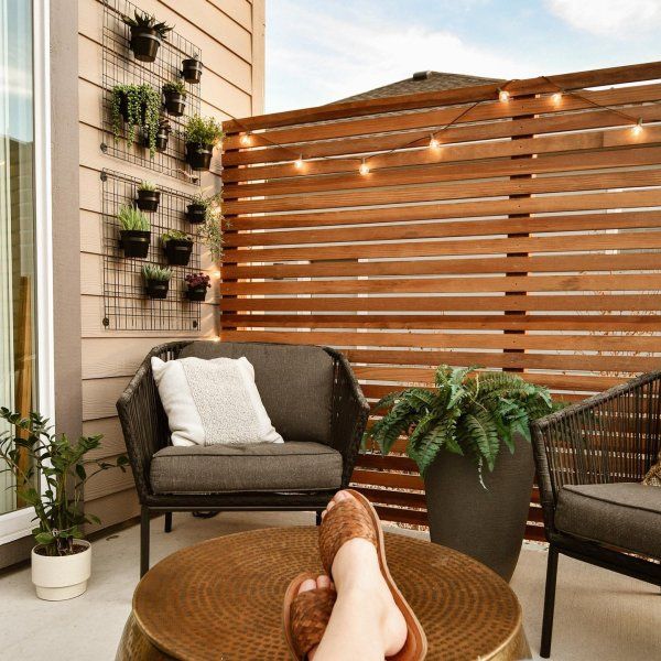 a person's feet resting on top of a table in front of a balcony