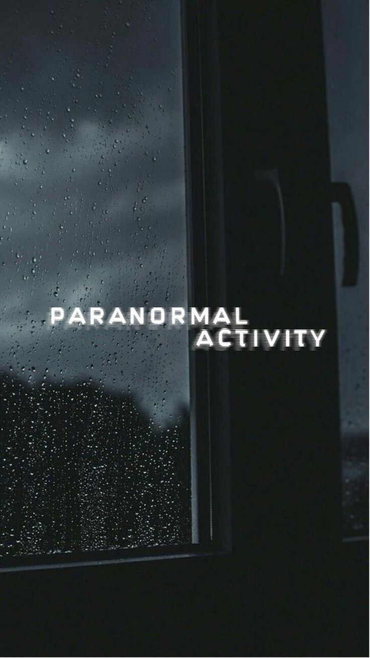 a window with rain drops on it and the words paranoral activity written in white