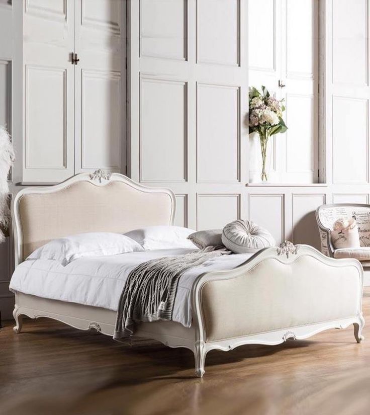 a white bed sitting in the middle of a room