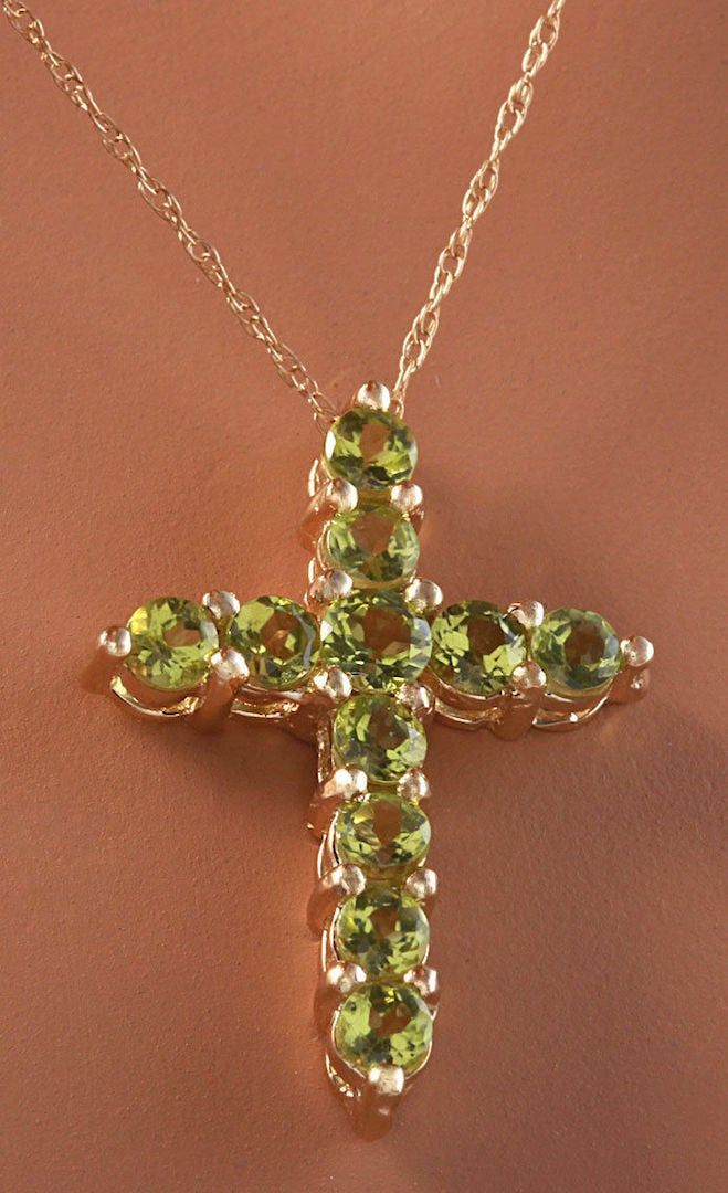 1.20 Carat Natural Green Peridot 14K Solid Yellow Gold Cross Pendant with Chain Amazing looking piece! Suggested Replacement Value: Approx. $1600.00 Total Natural Round Cut Green Peridots Weight: 1.20 Carat Chain Length is: 16 inches Pendant measures: Approx. 25 x 18.4mm Total item weight is: Approx. 2.1g Disclaimer: all weights, measurements and colors are approximate and may vary slightly from the listed dimensions or as seen in the image. All pictures are magnified to show the smallest of det Luxury Yellow Gold Peridot Jewelry, Yellow Gold Jewelry With Polished Tsavorite, Elegant Multi-stone Peridot Gemstones, Fine Jewelry Peridot Gemstones For Formal Occasions, Luxury Peridot Jewelry For Formal Occasions, Yellow Gold Polished Peridot Jewelry, Yellow Gold Peridot Jewelry With Polished Finish, Luxury Peridot Multi-stone Jewelry, Luxury Multi-stone Peridot Jewelry