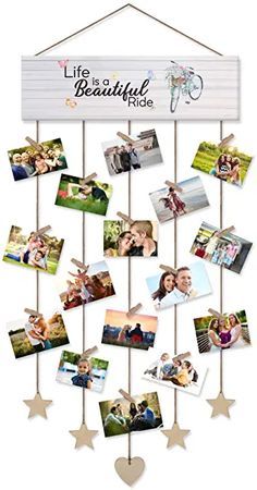 a white sign hanging from the side of a wooden pole with photos on it and stars