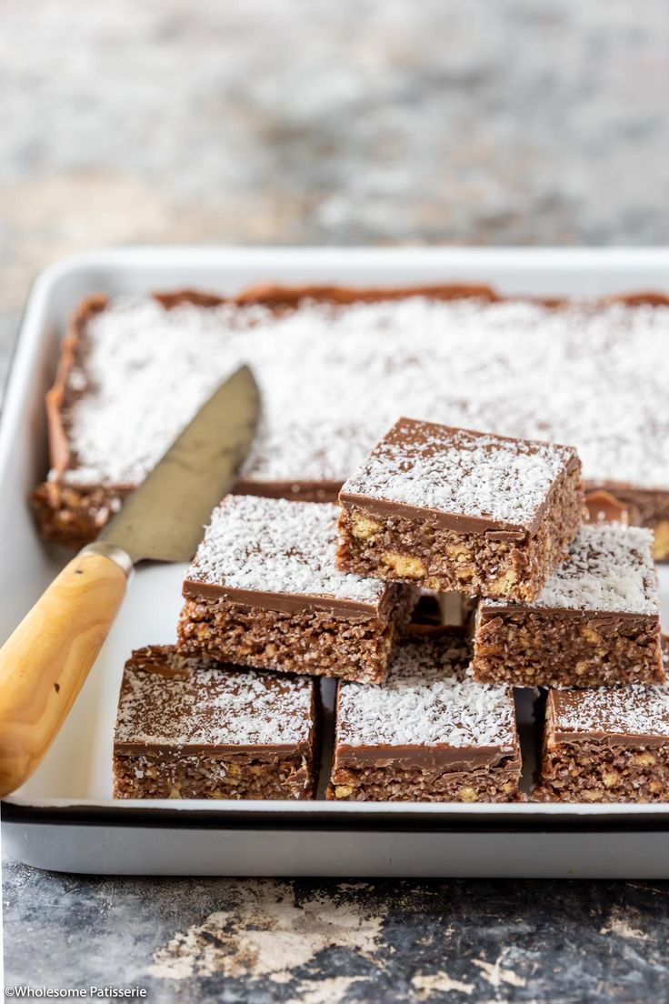 some brownies are on a plate with a knife