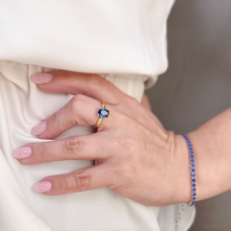 Discover elegance and timelessness with our 18k Gold Filled Royal Blue Solitaire Ring. Crafted with precision and detail, this ring exudes a regal allure that will elevate any outfit. A must-have for those who appreciate luxury and sophistication. Metal: 18k Gold filled Available sizes: 5.5, 6,7, 8, and 9 Hypoallergenic Water-resistant Handcrafted in Brazil Timeless Sapphire Ring For Gift, Timeless Sapphire Ring As Gift, Elegant Blue Diamond Ring In 14k Gold, Elegant Blue Jewelry With Halo Design, Elegant Oval Royal Blue Rings, Elegant Royal Blue Oval Rings, Elegant Sapphire Birthstone Ring In 14k Gold, Elegant 14k Gold Sapphire Halo Ring, Luxury Solitaire Sapphire Promise Ring