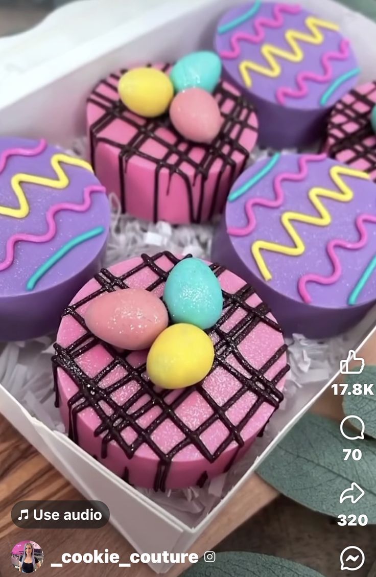 four decorated cookies in a white box on a table with text overlay that says cookie couture