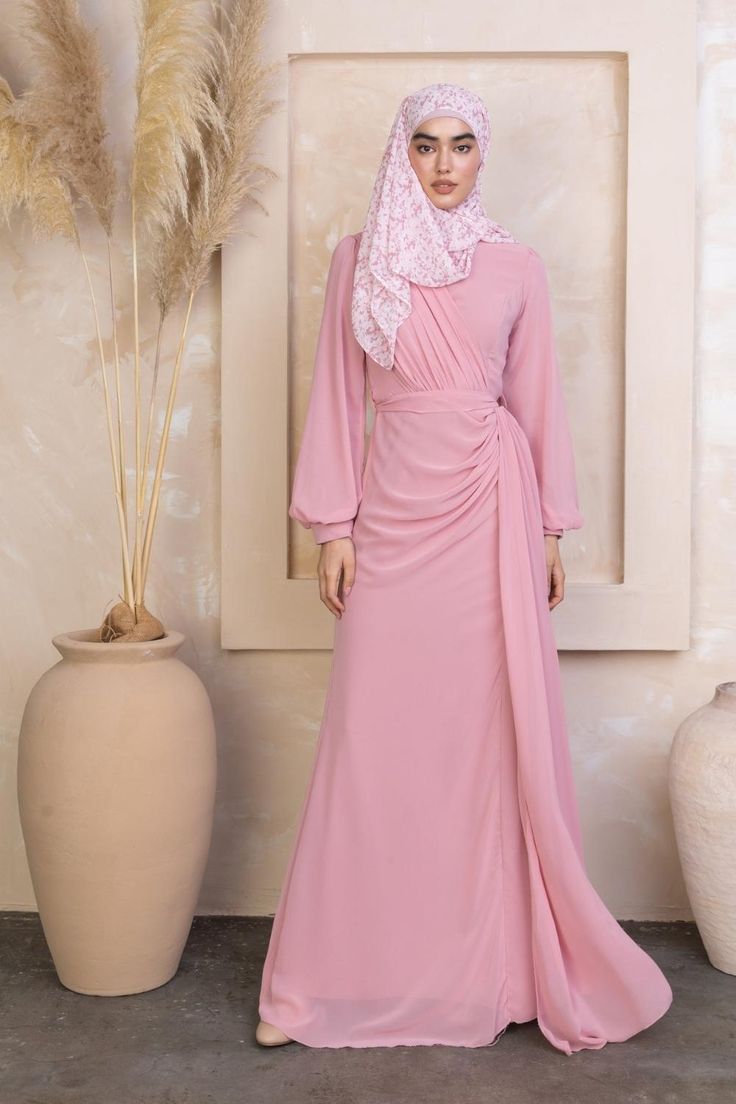 a woman wearing a chiffon long sleeve gown Pre-draped Long Sleeve Wedding Gown, Long Sleeve Pre-draped Maxi Dress For Wedding, Ruched Long Sleeve Chiffon Dress, Chiffon Long Sleeve Maxi Dress With Ruched Detail, Long Sleeve Chiffon Dress With Ruched Details, Long Sleeve Ruched Chiffon Maxi Dress, Pink Long Sleeve Chiffon Maxi Dress, Chiffon Maxi Dress With Sheer Long Sleeves, Long Sleeve Ruched Chiffon Dress