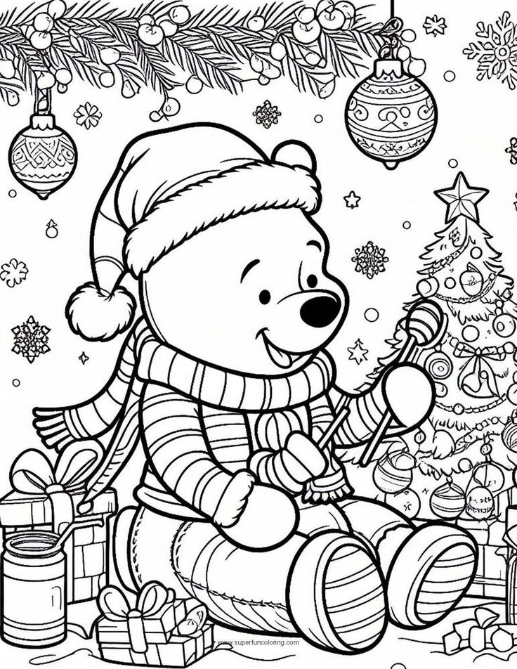 a teddy bear sitting next to a christmas tree