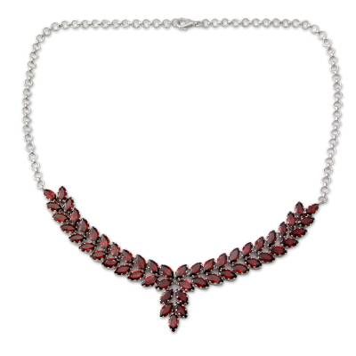 Alok Jain of India presents a garnet necklace that is truly worthy of royalty. He sets a stunning 25 carats of the faceted crimson stones in gleaming rhodium plated sterling silver and suspends the pendant from a classic silver rolo chain. The result is a breathtaking statement necklace.Rhodium plated .925 sterling silver Luxury Red Sterling Silver Necklace, Luxury Garnet Pendant Necklace, Elegant Silver Garnet Necklace, Elegant Red Faceted Necklace, Formal Garnet Fine Jewelry Necklace, Elegant Garnet Necklace For Formal Occasions, Round Garnet Gemstone Necklaces, Formal Garnet Faceted Jewelry, Elegant Garnet Pendant Necklace