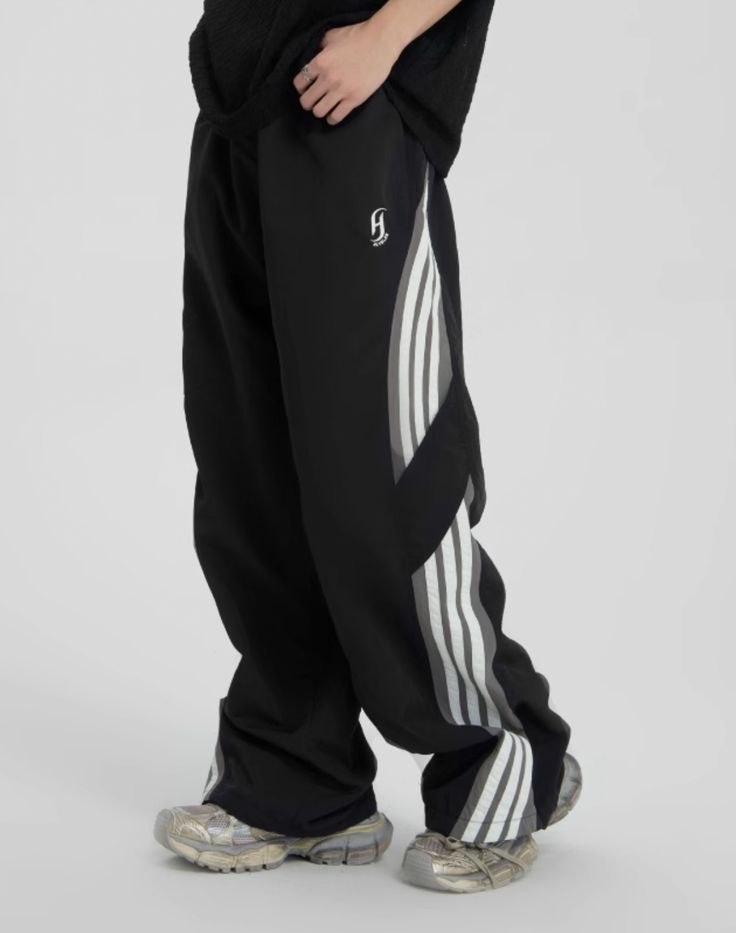 Comfort and Style Introducing the Striped Paratrooper Sports Rushing Pants, designed for ultimate comfort and a sleek, stylish look. These pants are perfect for those who value both aesthetics and functionality in their athletic wear. Size Guidance Choosing the right size is crucial for optimal comfort. Refer to the size suggestions below to find your perfect fit: S-M: Suitable for individuals with a height of 160-170cm and weight of 45-55kg. M-L: Ideal for those with a height of 170-175cm and w Three Stripes Sportswear Pants For Jogging, Sportswear Pants With Three Stripes, Sports Sweatpants With Three Stripes, Urban Style Sports Bottoms With Tapered Leg, Urban Tapered Leg Sports Bottoms, Casual Gym Pants With Three Stripes, Athleisure Wide-leg Sweatpants For Streetwear, Sporty Jogging Pants With Three Stripes, Sporty Three-stripe Pants For Jogging