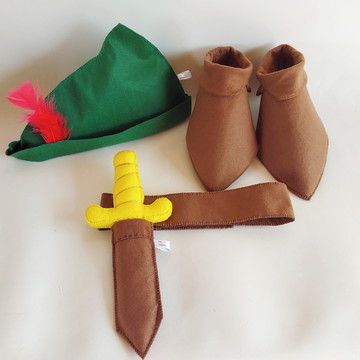 a pair of brown boots and a green hat on a white surface with two yellow handles