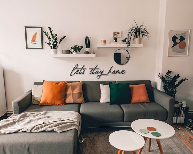 a living room filled with furniture and plants