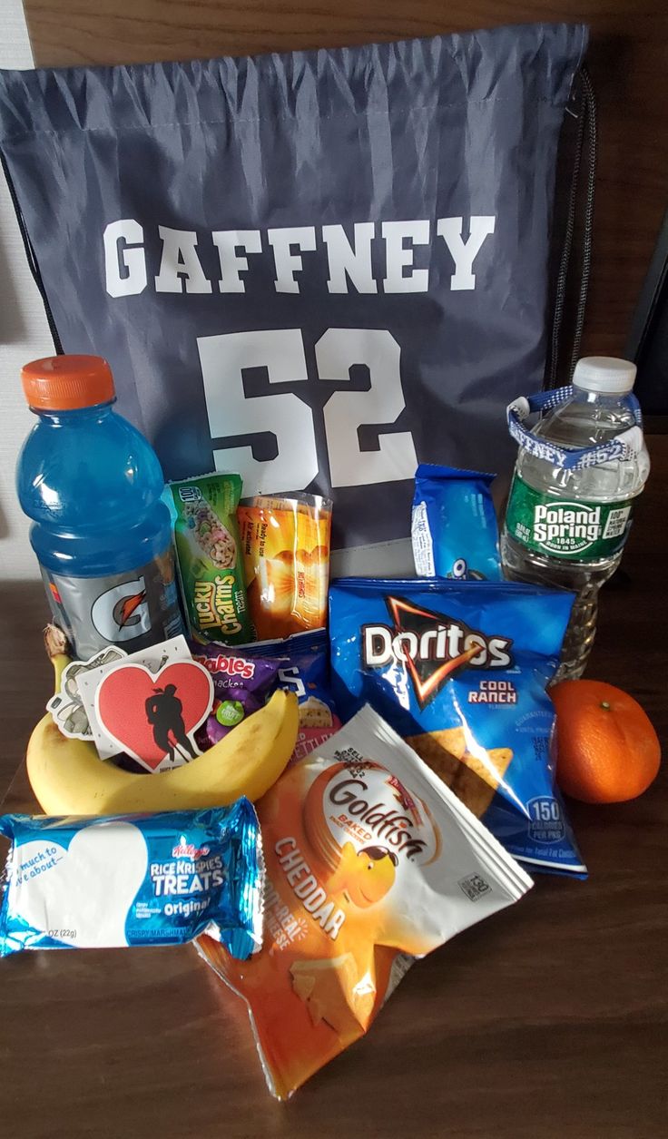 an assortment of snacks sitting on top of a wooden table next to a sign that says gaffney 52