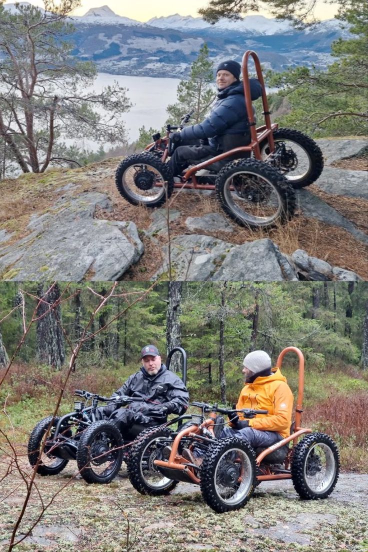 two men riding four wheelers on top of a hill next to trees and water