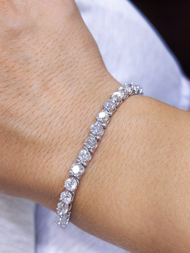 This stylish floral bracelet features 9.25 ct of round diamonds, set in 14K white gold three-prong setting. All jewelry sales come with an appraisal including replacement value. Exquisite Platinum Tennis Bracelet With Diamond Accents, Exquisite Diamond Bracelet With Prong Setting For Formal Occasions, Fine Jewelry Platinum Diamond Bracelet With Prong Setting, Platinum Diamond Bracelet With Prong Setting, Dazzling Platinum Bracelet With Prong Setting, Dazzling Platinum Bracelets With Prong Setting, Elegant Sterling Silver Bracelet With Moissanite And Prong Setting, Elegant Sterling Silver Moissanite Bracelet With Prong Setting, Exquisite White Gold Tennis Bracelet With Prong Setting