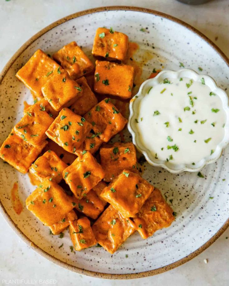 a plate with tofu and ranch dressing on it