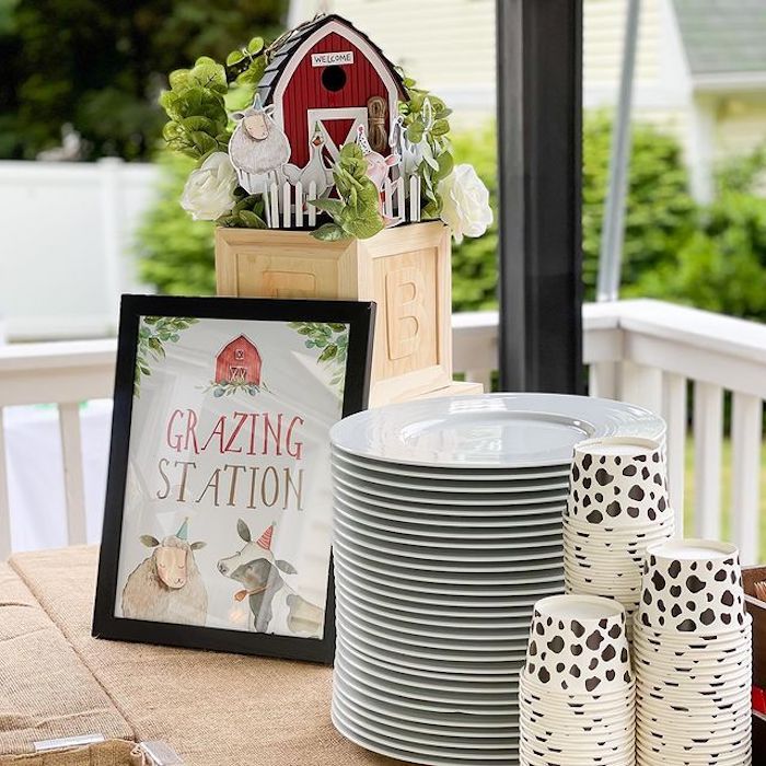 there is a table with plates and vases on it, along with other decorations