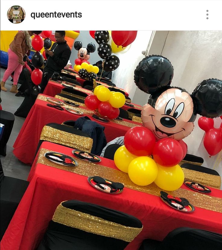 mickey mouse balloon centerpieces on red and gold tables