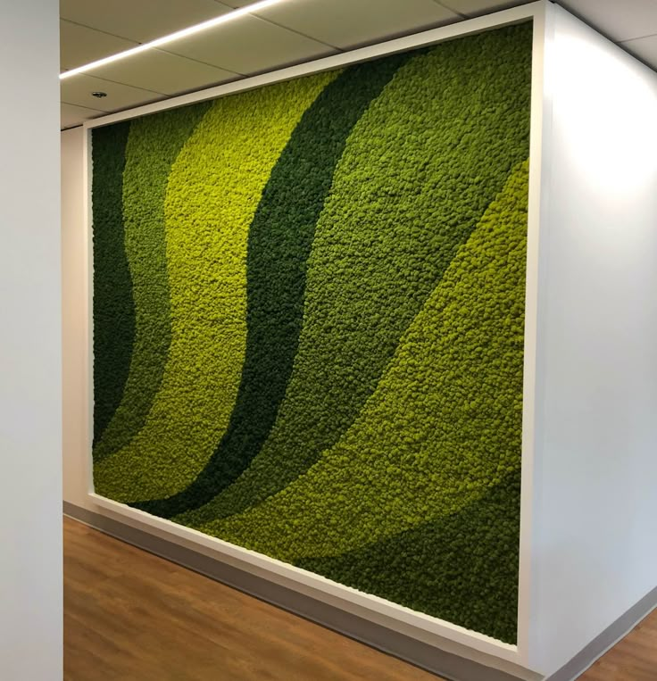 an office wall with grass growing on it