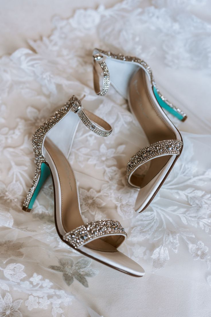 the bride's shoes are sitting on her wedding dress